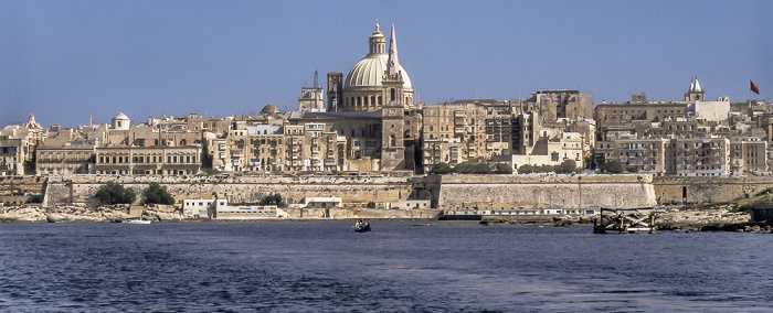 Blick von der Fähre Sliema - Valletta: Marsamxett Harbour (Il-Port ta' Marsamxett), Kuppel der Basilica of Our Lady of Mount Carmel (Karmelitenkirche) und Turm der Saint Paul's Anglican Cathedral (Il-Katidral Anglikan ta' San Pawl) Valletta